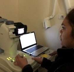 Staff member using a retinal camera