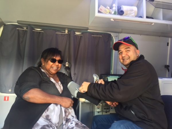 Norman Dulvarie works with a patient in the outreach van